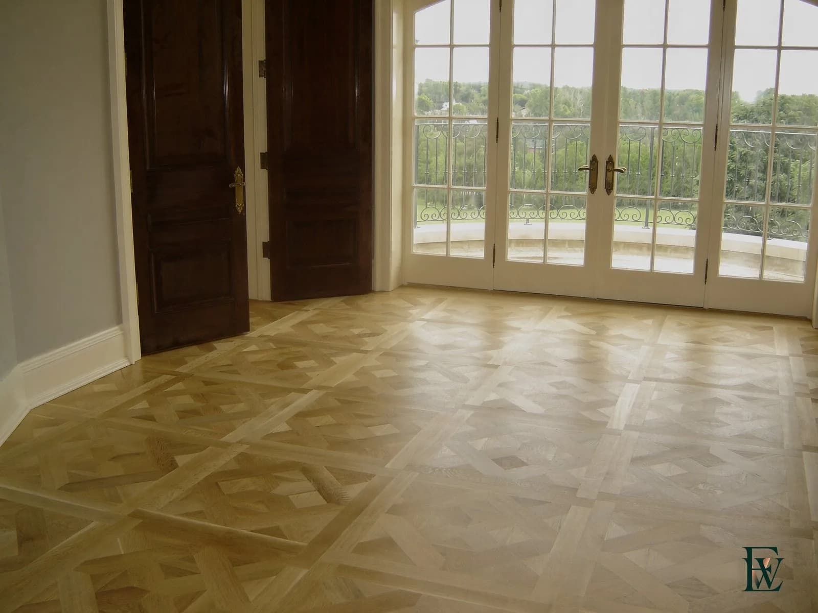 Light oak geometric parquet floor running to French balcony doors, frame 1 of 3, standing room view, Ecowoods site work, Toronto.