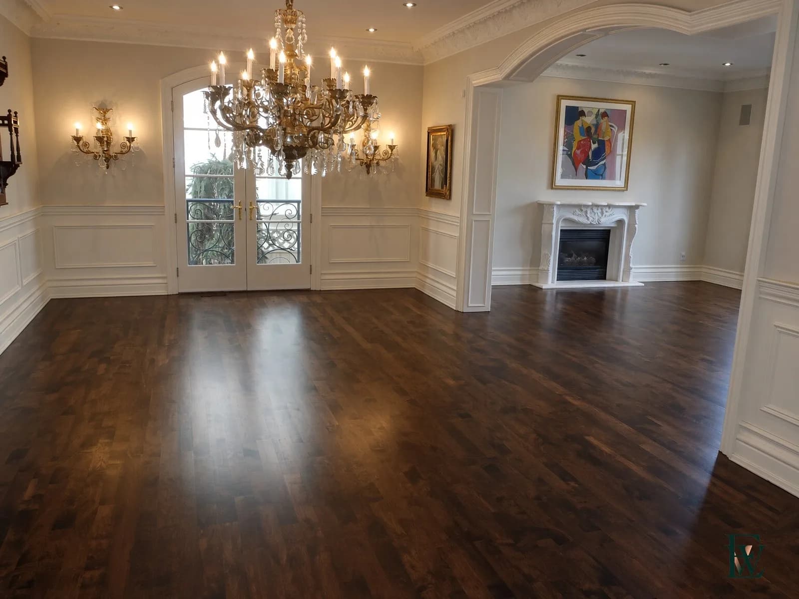 Oak floor running continuously through an archway between a salon and a fireplace room, frame 1 of 3, both rooms in view, Ecowoods site work, Toronto.